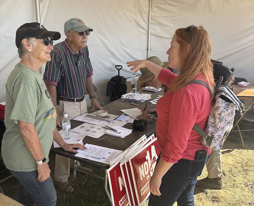 Barbara and Peter Shaw talk with fairgoers at the Common Ground Country Fair in Unity on Sunday.